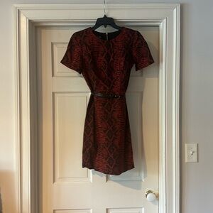 Above knee length, fitted dress with belt.